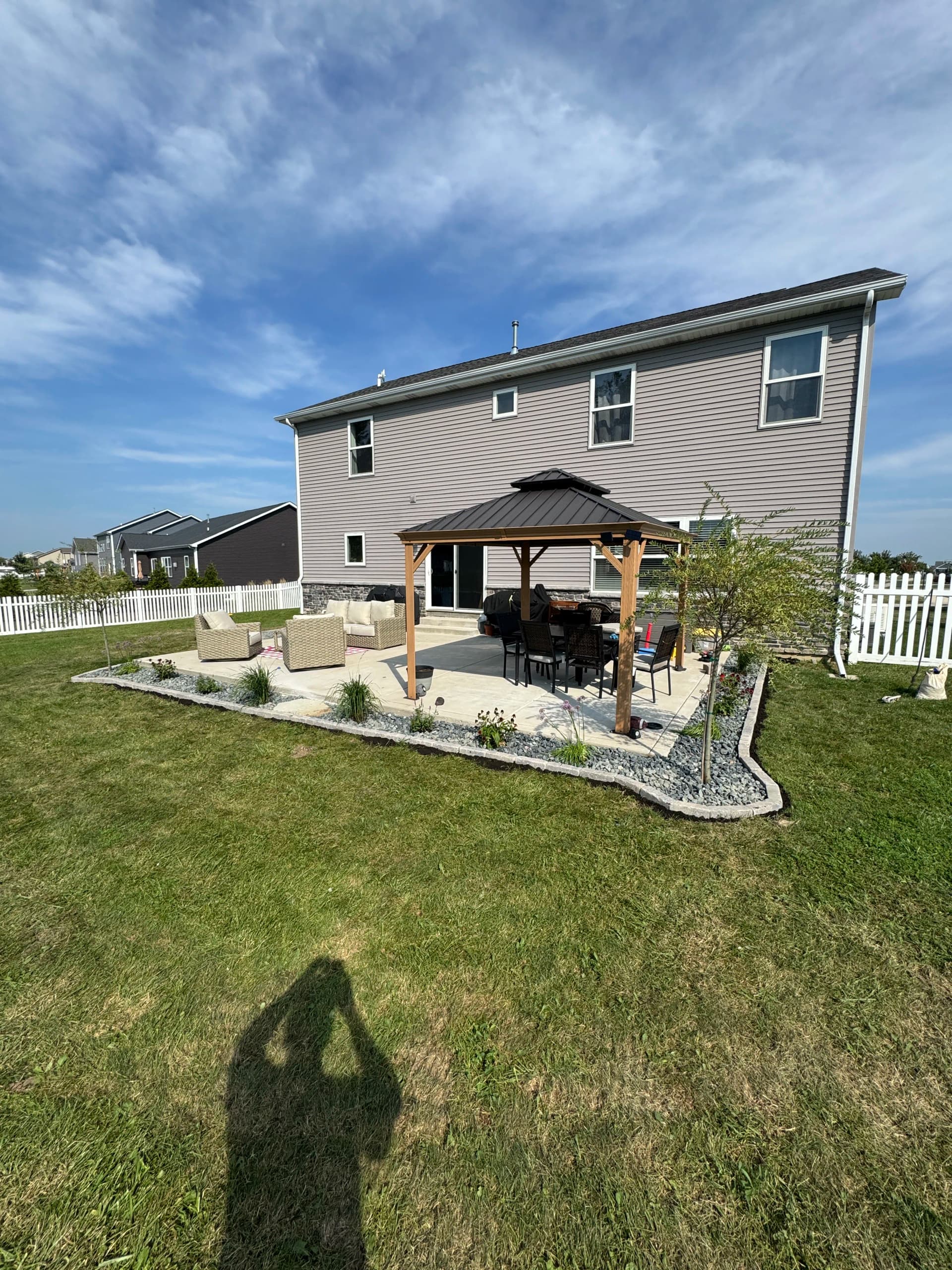 Paver Border, Rock, and New Plants Give This Backyard a Finished Look
