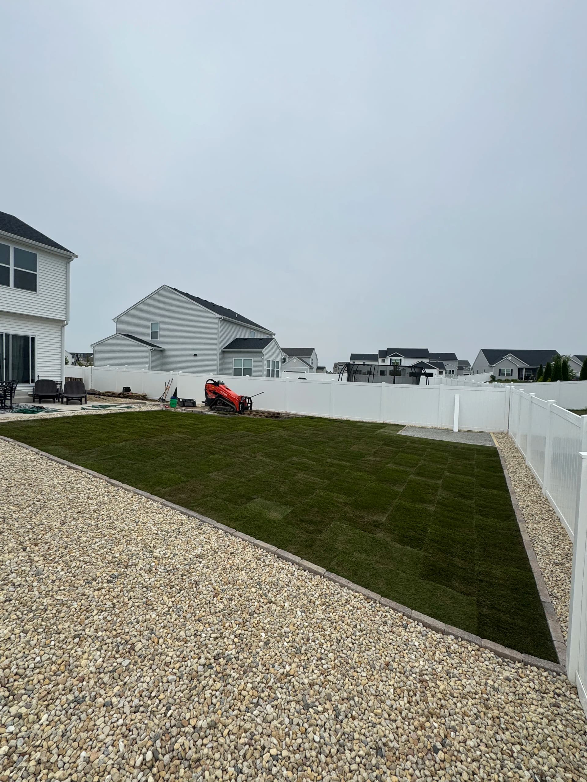 Bare Clay Backyard Gets Sod, Gravel and Flagstone Makeover image